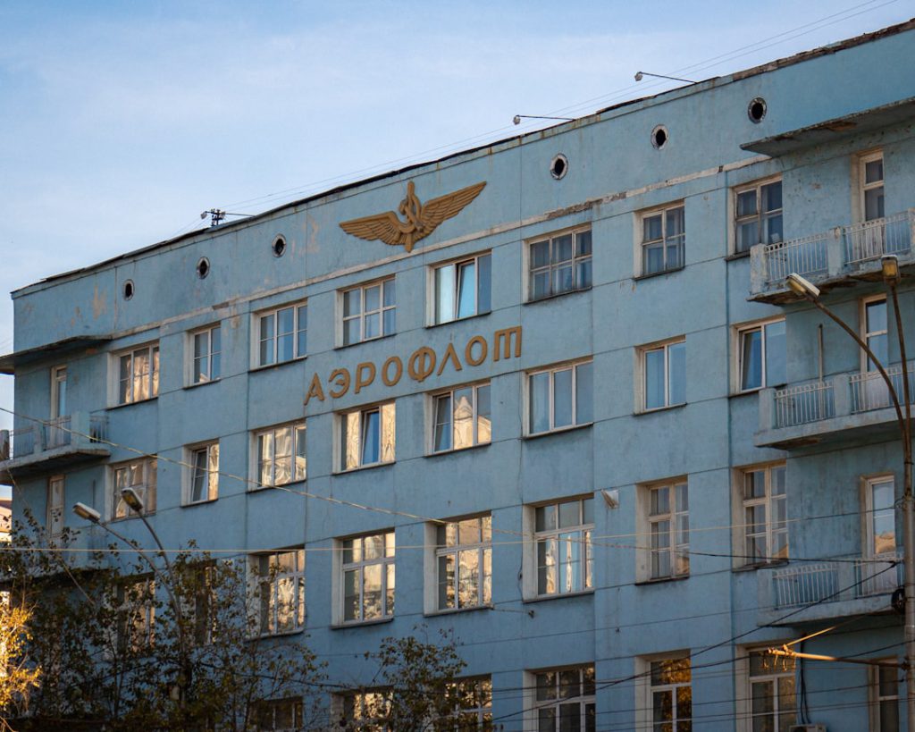 a large blue building with a golden eagle on it