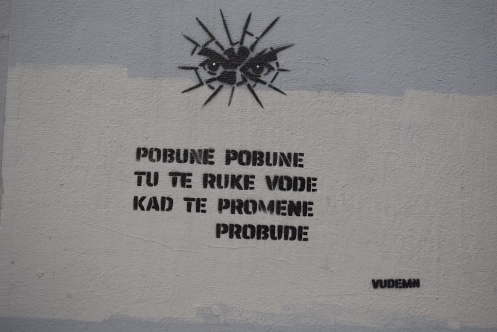 Graffiti with eyes and text on a wall